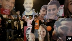 Demonstrators hold portraits of hostages held by Hamas in the Gaza Strip during a protest calling for their immediate release in Tel Aviv, Israel, Jan. 18, 2025.